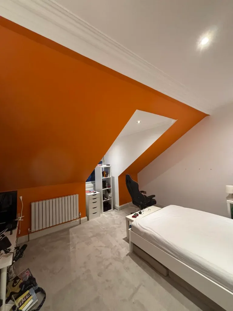 Modern bedroom with angled orange wall
