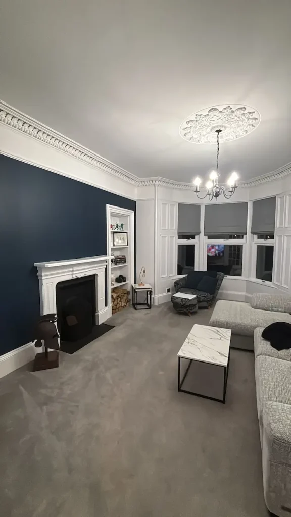 Living room decorated, navy blue accent wall